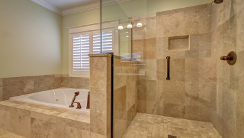 beautiful stone tile bathroom and clean shower door
